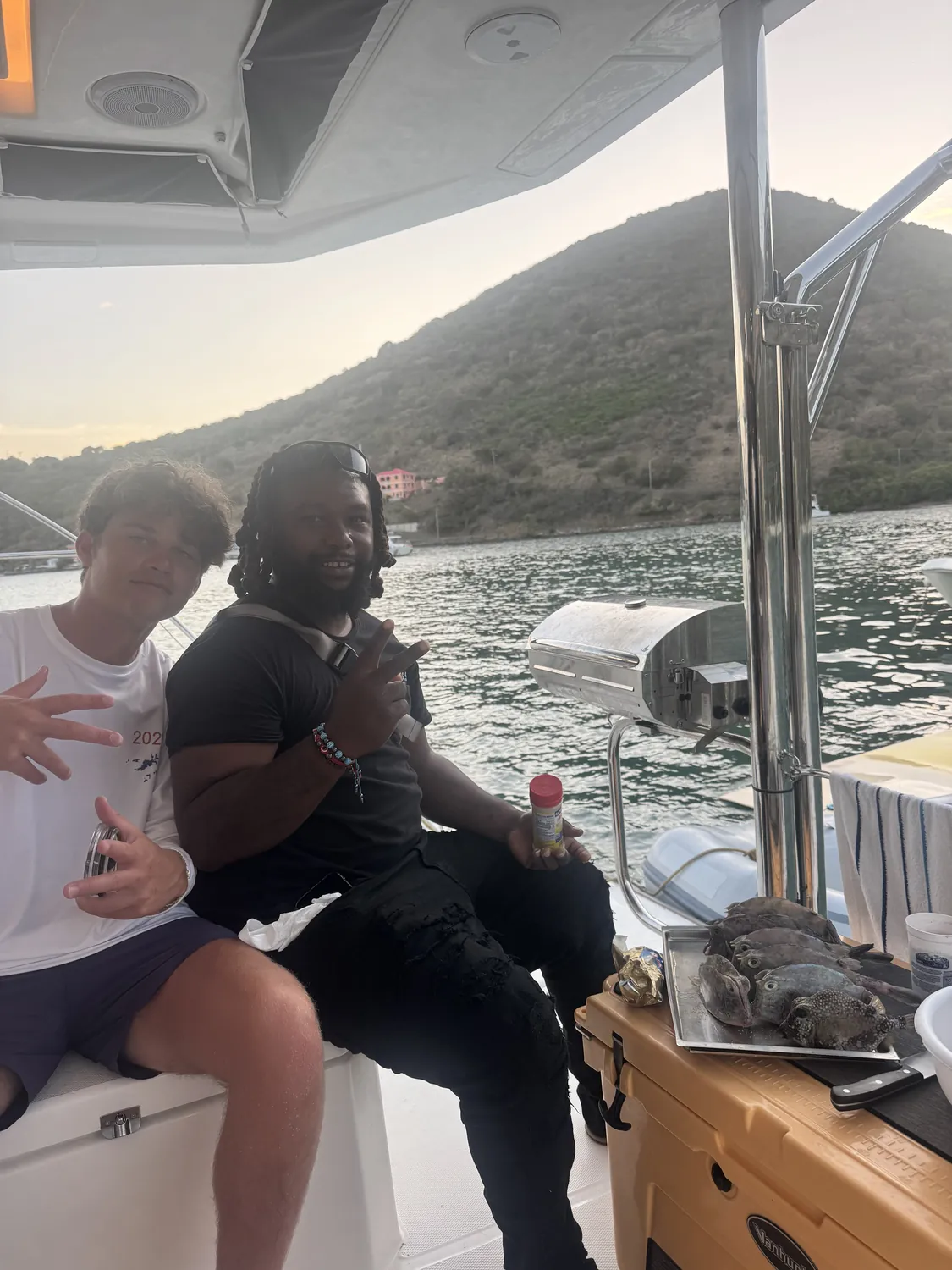 Captain Teno and a guest at sunset with the day's fresh catch